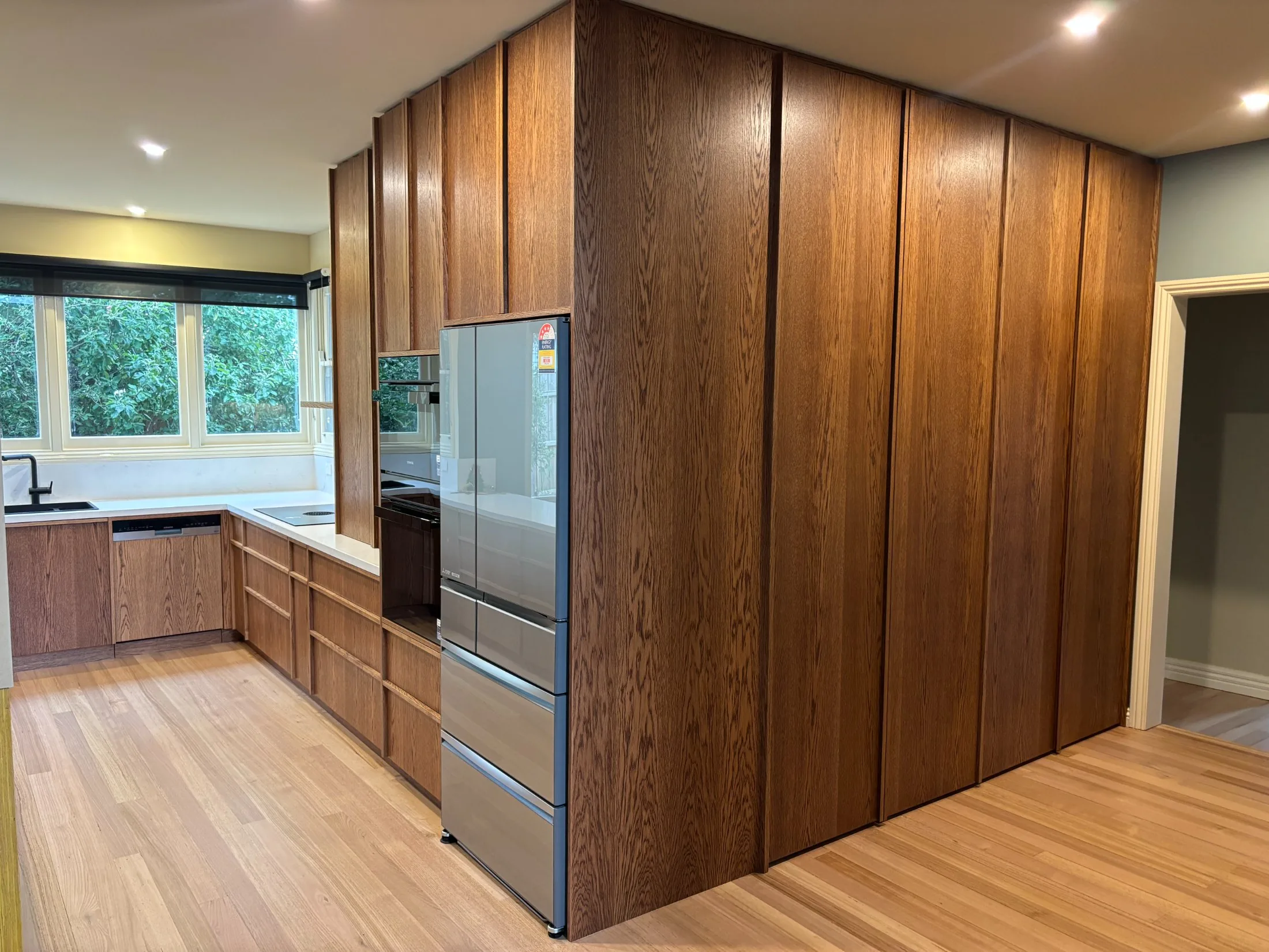 Full-height timber grain cabinetry wall
